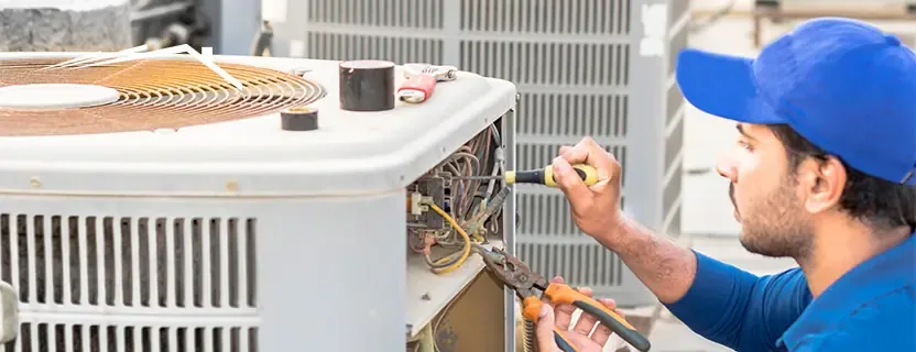 HVAC technician servicing a residential heating and cooling system in East Aurora NY